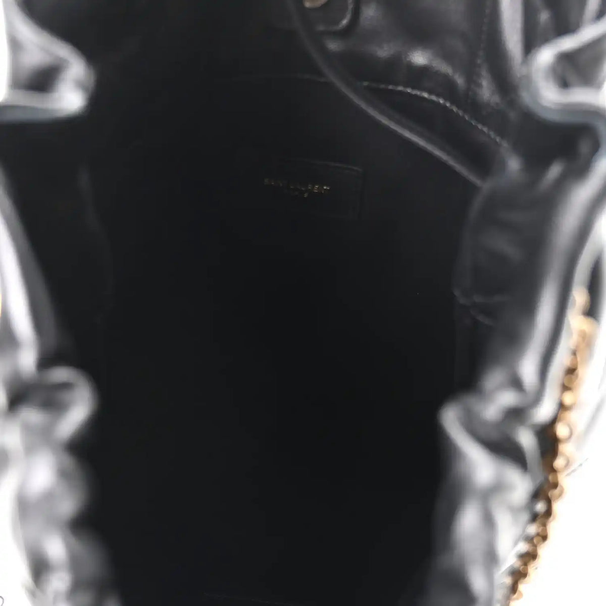 Black leather interior panel with embossed Saint Laurent logo