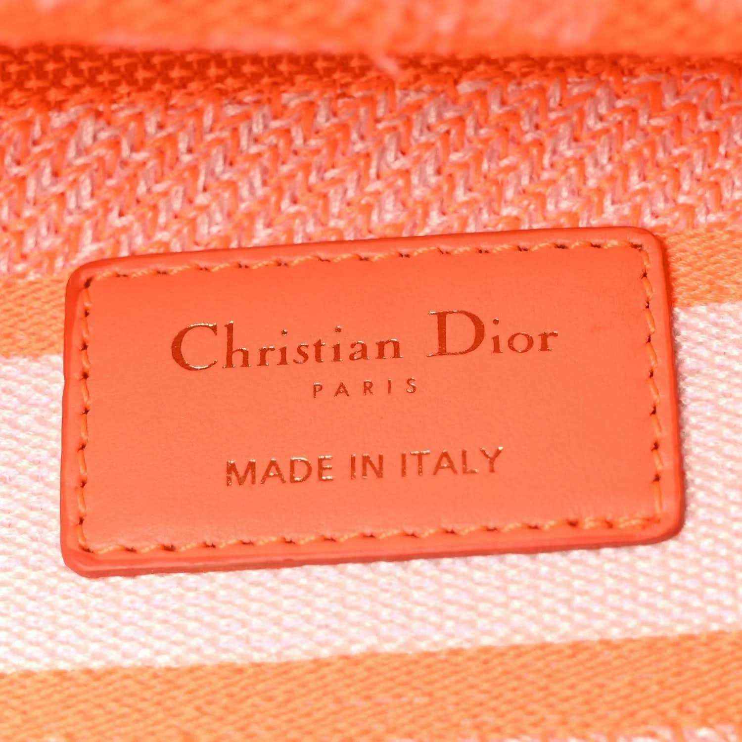 Orange leather label on the bag reading Christian Dior PARIS, made in Italy.