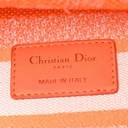 Orange leather label on the bag reading Christian Dior PARIS, made in Italy.