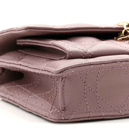 Closeup of purple quilted leather flap and inner pocket opening