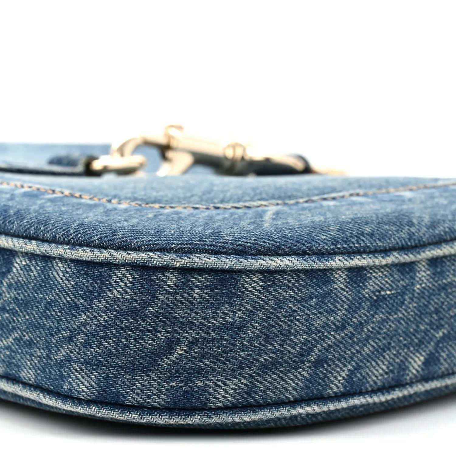 Blue denim Jackie bag top edge with gold-tone hardware and stitched trim