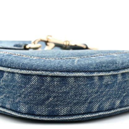 Blue denim Jackie bag top edge with gold-tone hardware and stitched trim