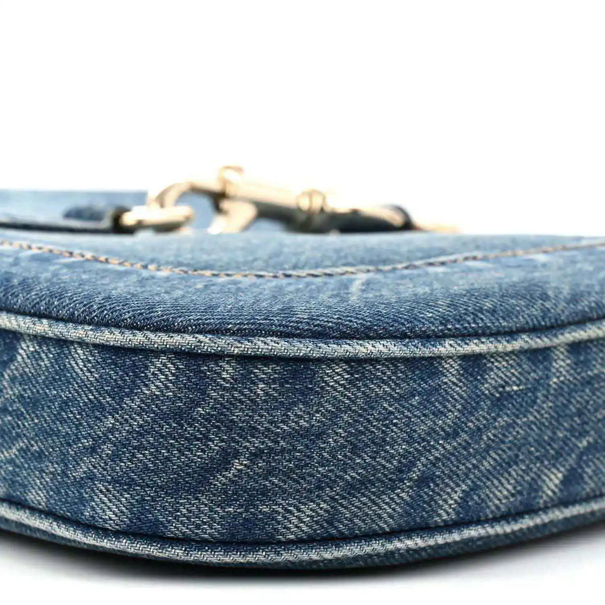 Blue denim Jackie bag top edge with gold-tone hardware and stitched trim