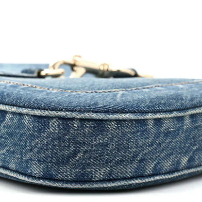 Blue denim Jackie bag top edge with gold-tone hardware and stitched trim