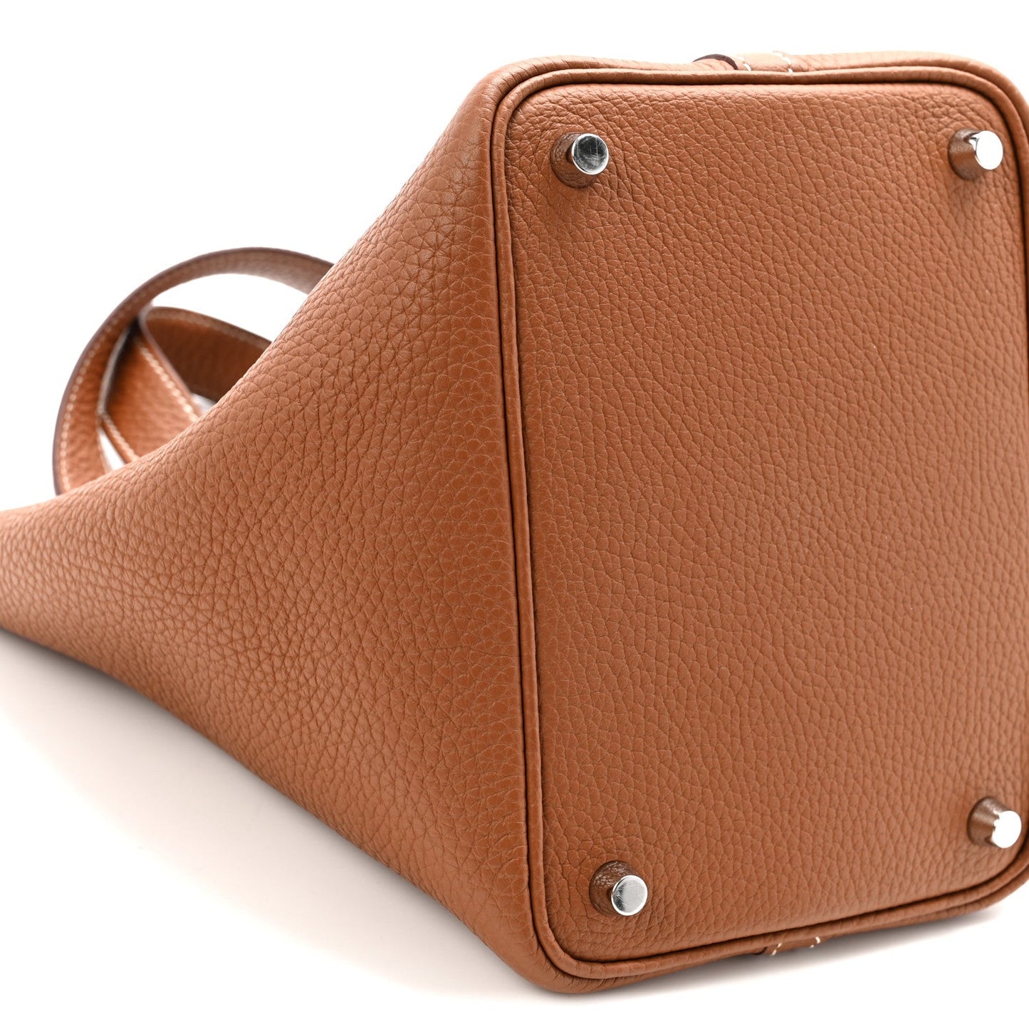 Cognac brown leather tote bag with corner rivets and top edge detail