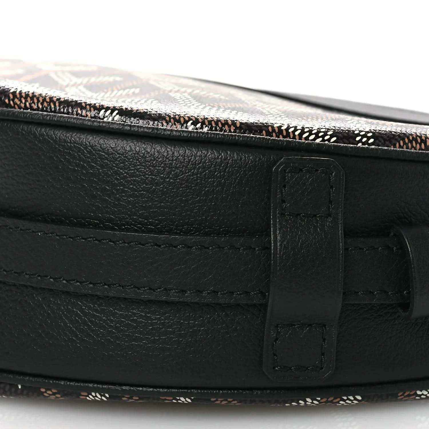 Black leather strap and buckle closure on crossbody handbag