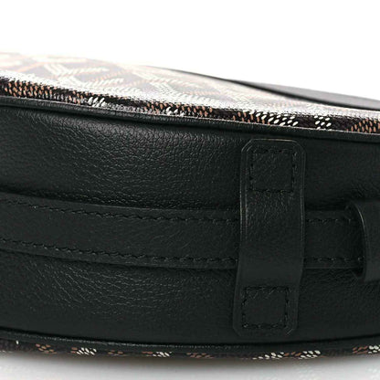 Black leather strap and buckle closure on crossbody handbag