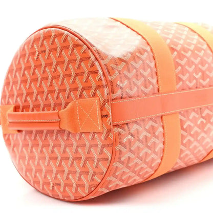 Orange monogram canvas barrel sports bag with zippered end compartment and tab.