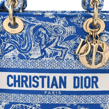 Christian Dior medium tote bag front in blue and white toile print with CD charms and logo stripe