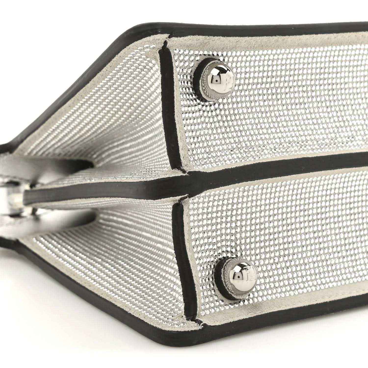 Petite Peekaboo satchel bag close-up of crystal front panels with metal logo emblems