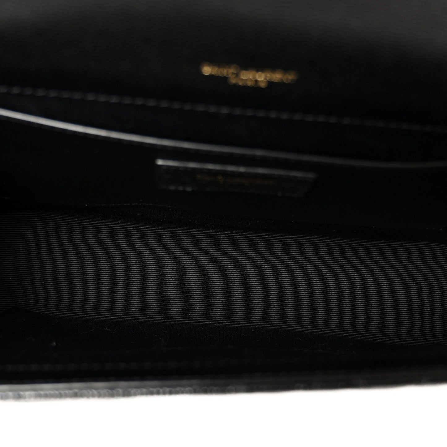Black satchel bag interior with embossed logo detail