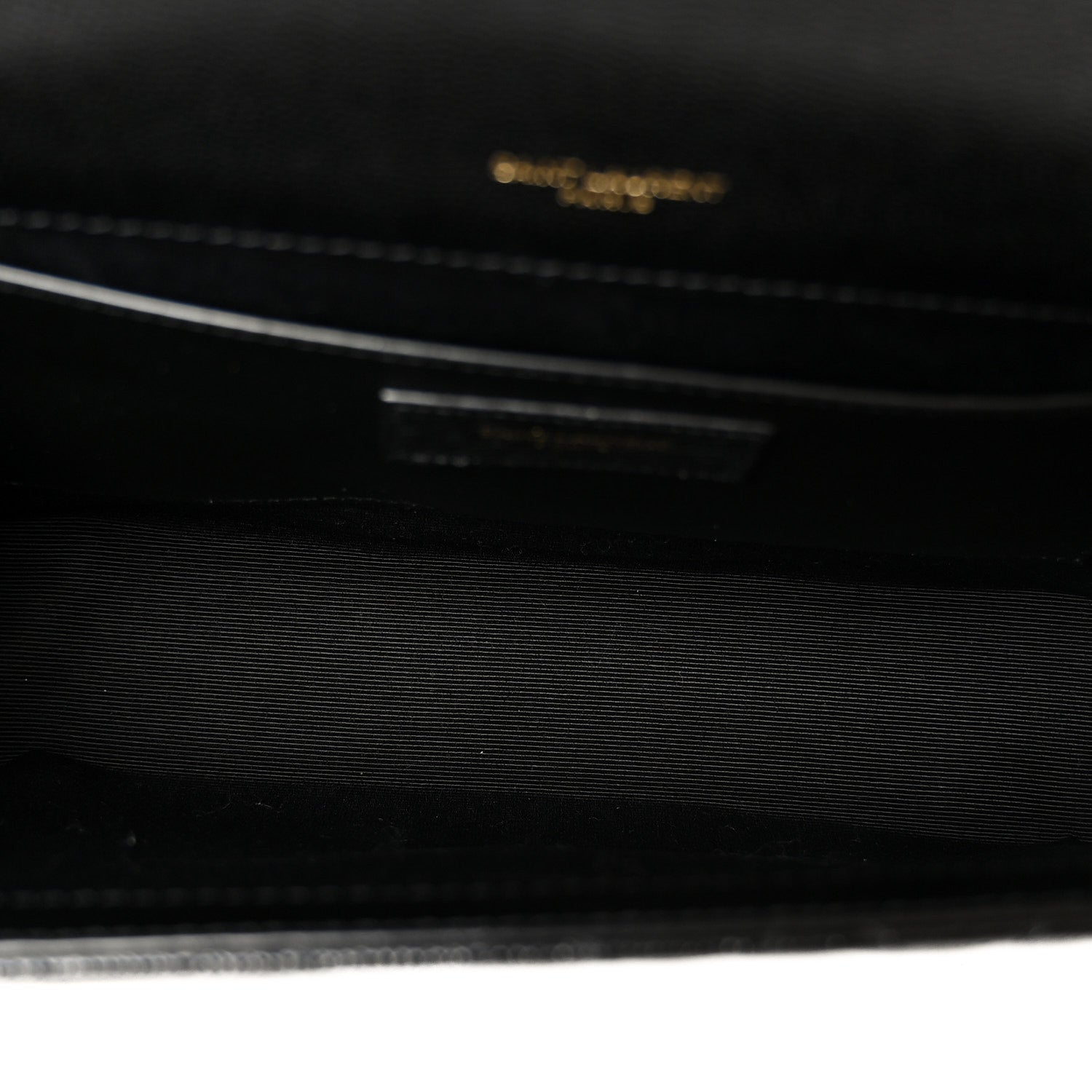 Black satchel bag interior with embossed logo detail
