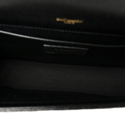Black satchel bag interior with embossed logo detail