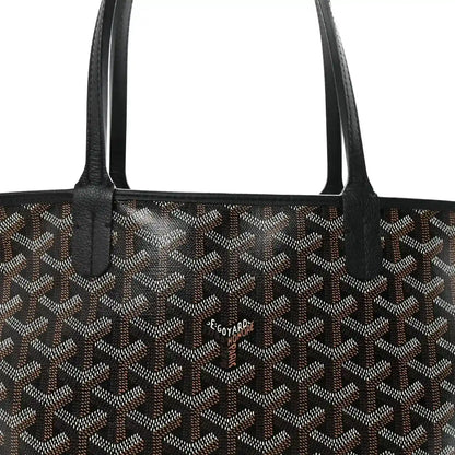 Goyardine tote bag front with black handles and small brand patch.