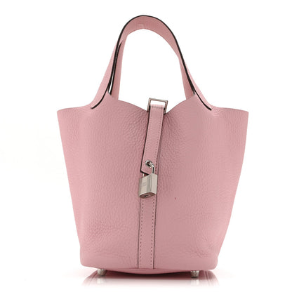Mauve textured leather tote-style handbag with central padlock closure
