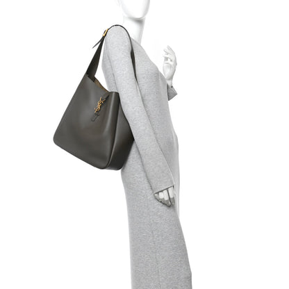 Saint Laurent smooth calfskin hobo bag in light musk with top handle and YSL detail