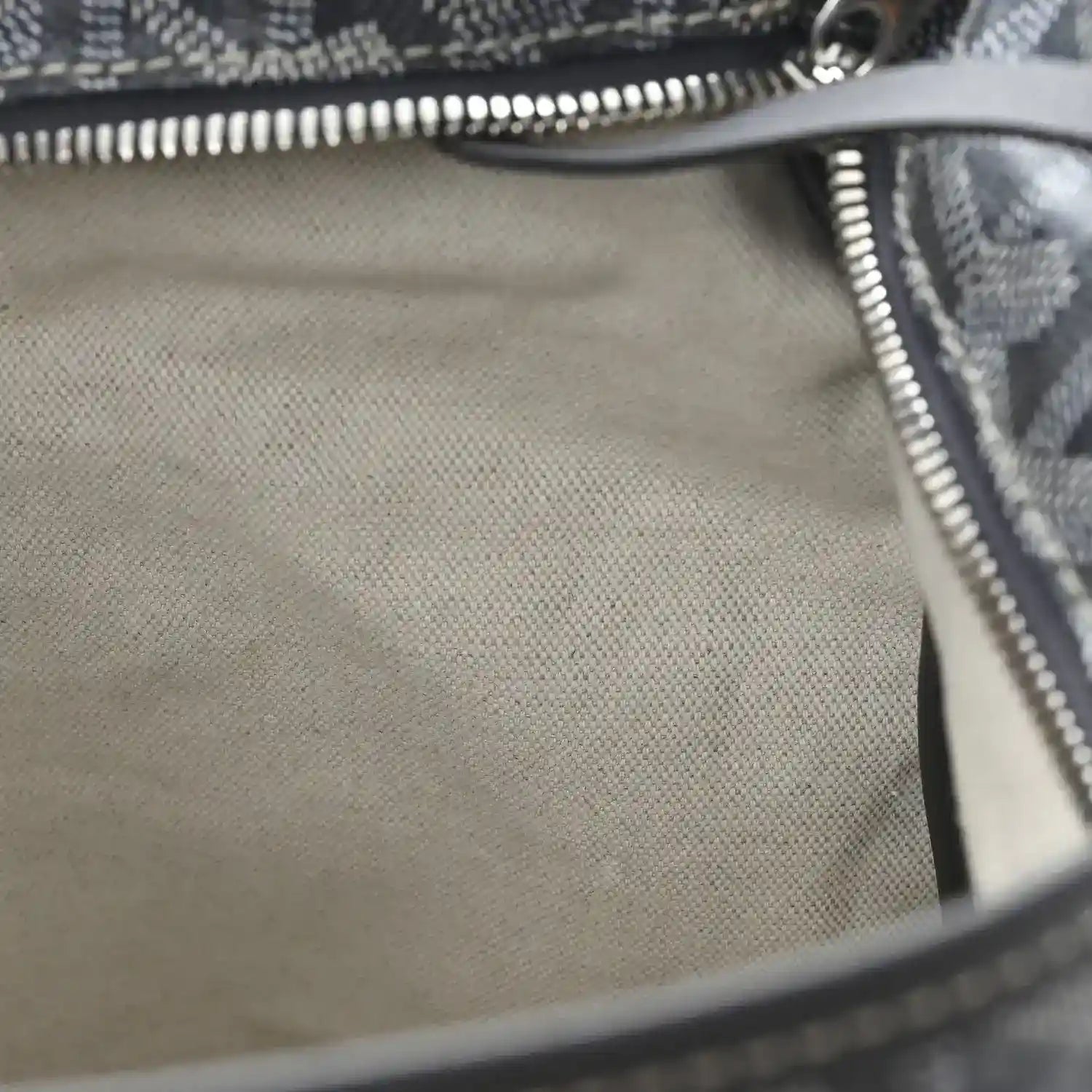 Hobo bag interior with beige lining and silver zipper trim