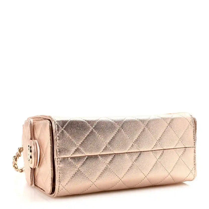 Copper metallic quilted mini handbag with flap front and gold-tone chain strap.