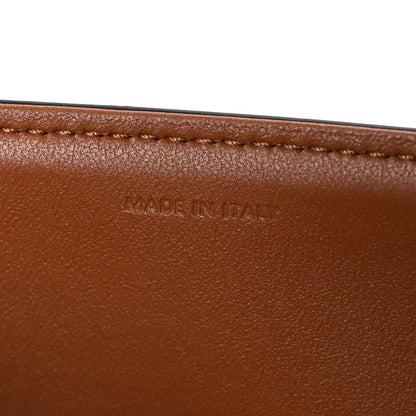 Tan leather edge with “MADE IN ITALY” stamped text and stitched border.