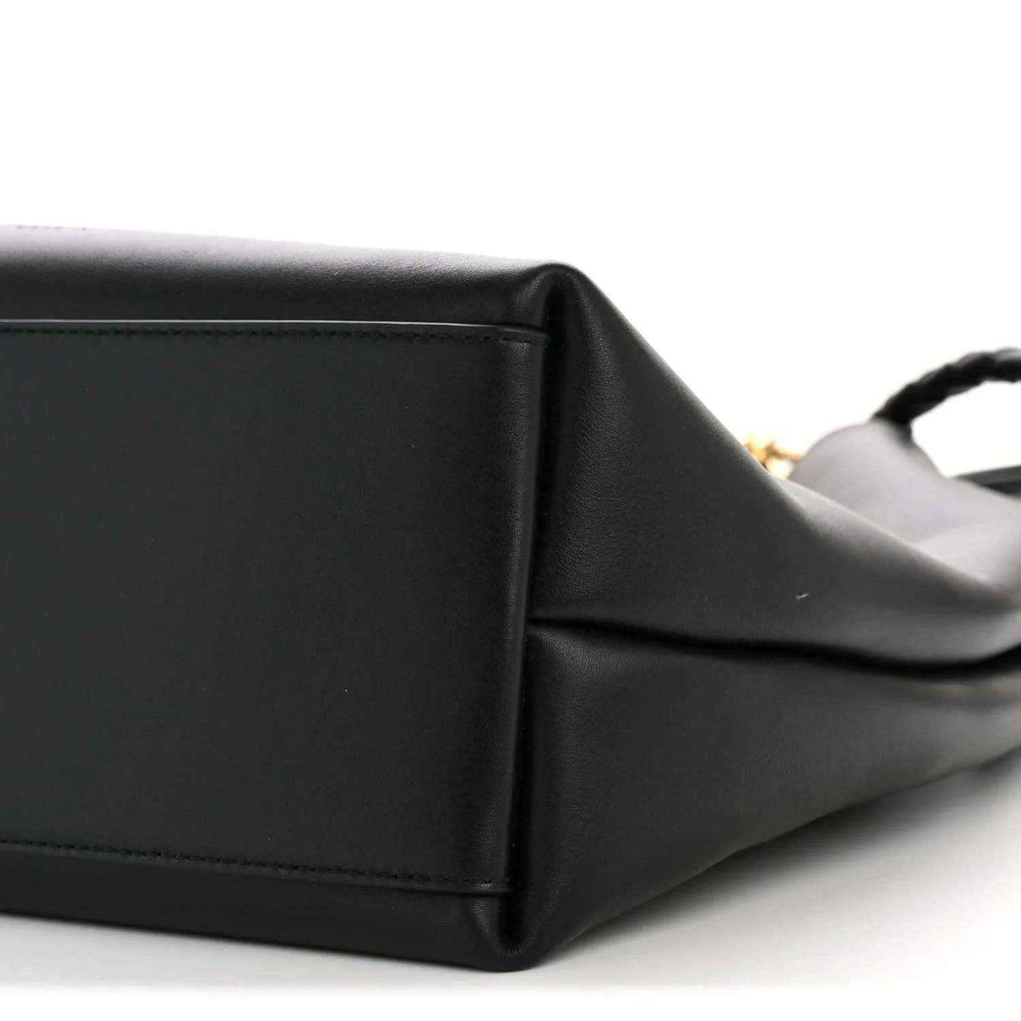 Black bucket bag corner with stitching and folded leather edge