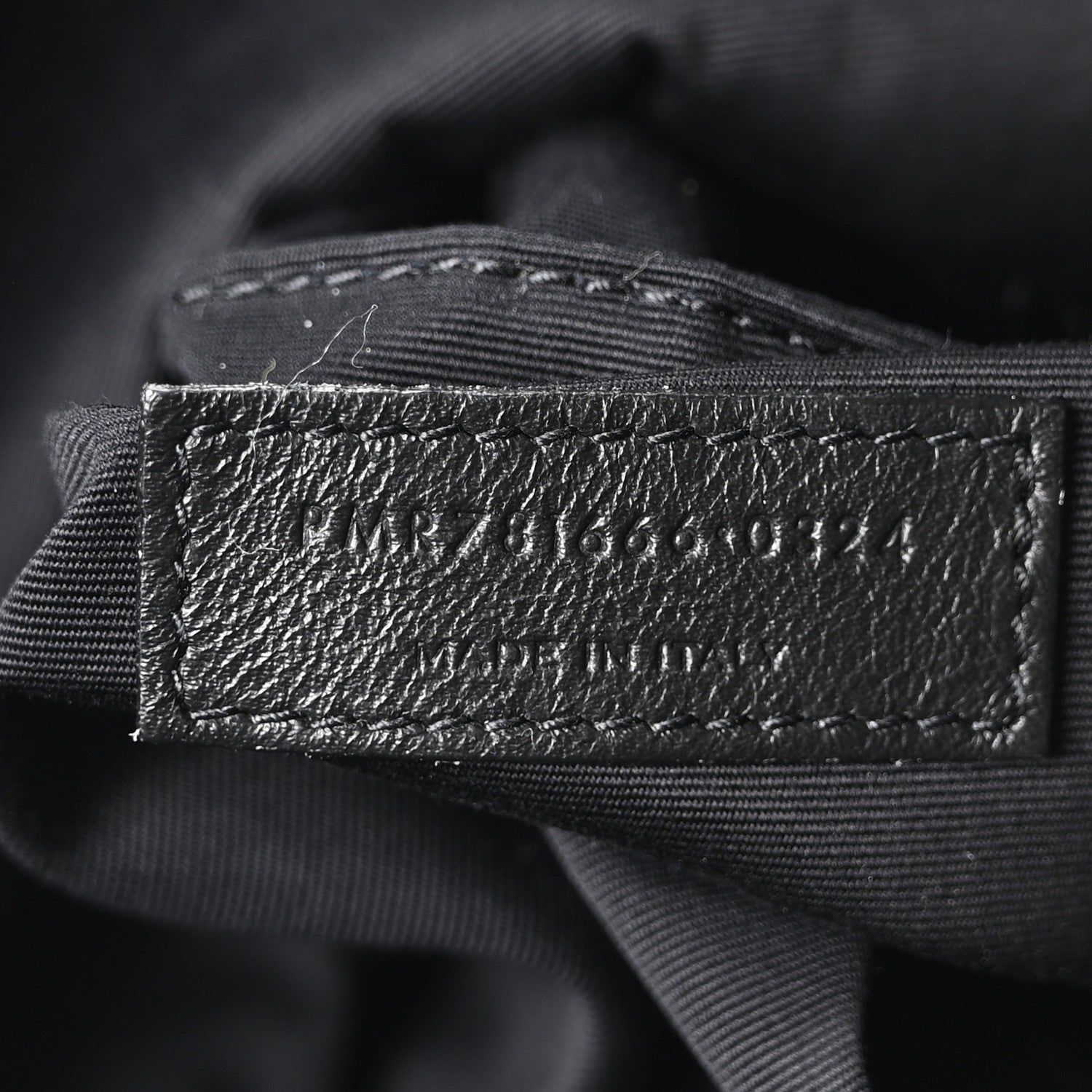 Black fabric lining label with SAINT LAURENT PARIS text