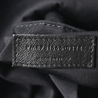 Black fabric lining label with SAINT LAURENT PARIS text