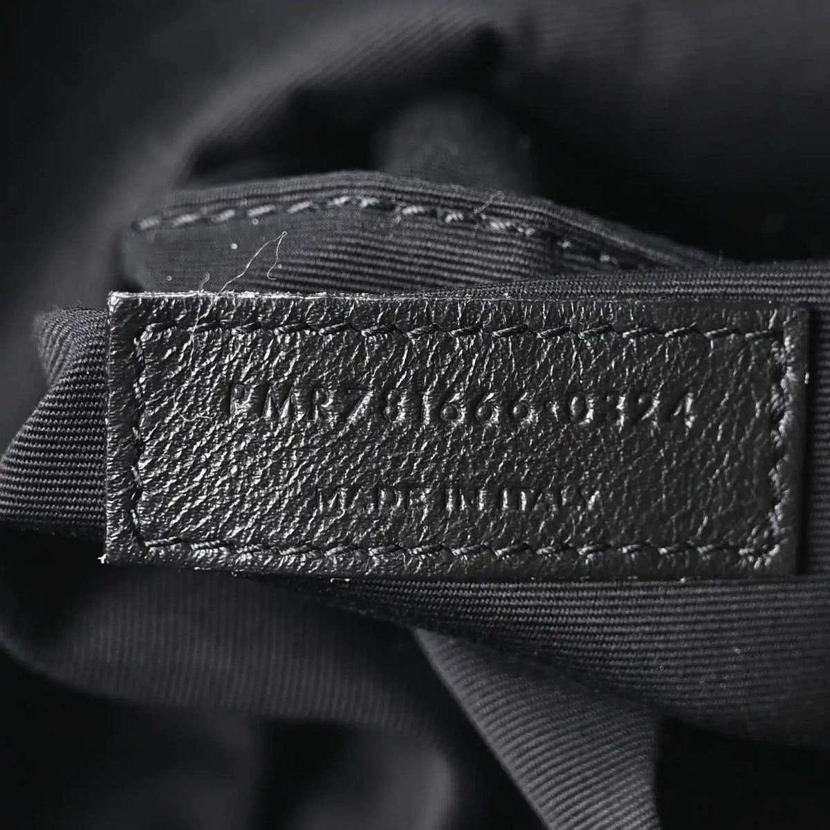 Black fabric lining label with SAINT LAURENT PARIS text