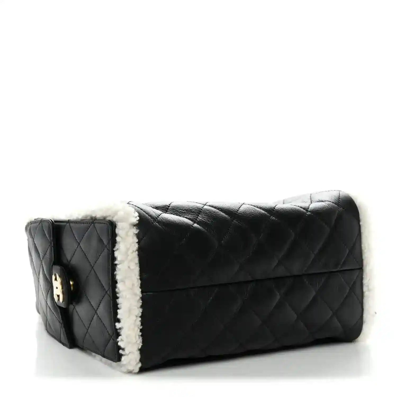 Black quilted leather handbag with white shearling trim and flap front