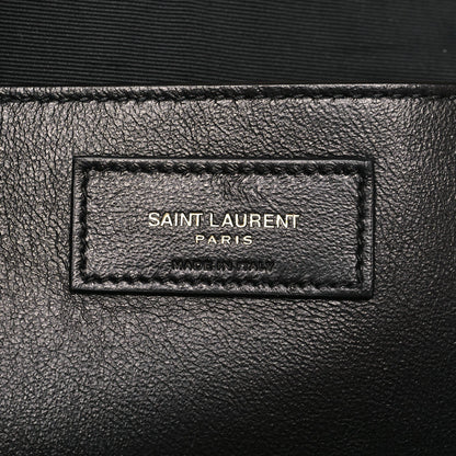 Rectangular leather brand label on bag, stamped text inside border stitching.