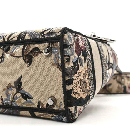 Floral canvas tote corner with silver studs and striped band, side profile.