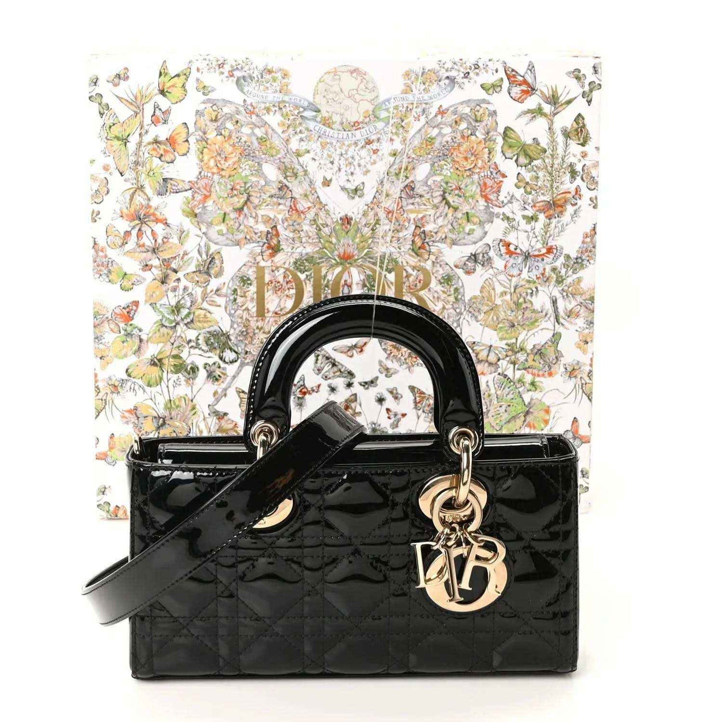 Black patent leather Lady D-Joy bag with top handles, quilted front, and charm