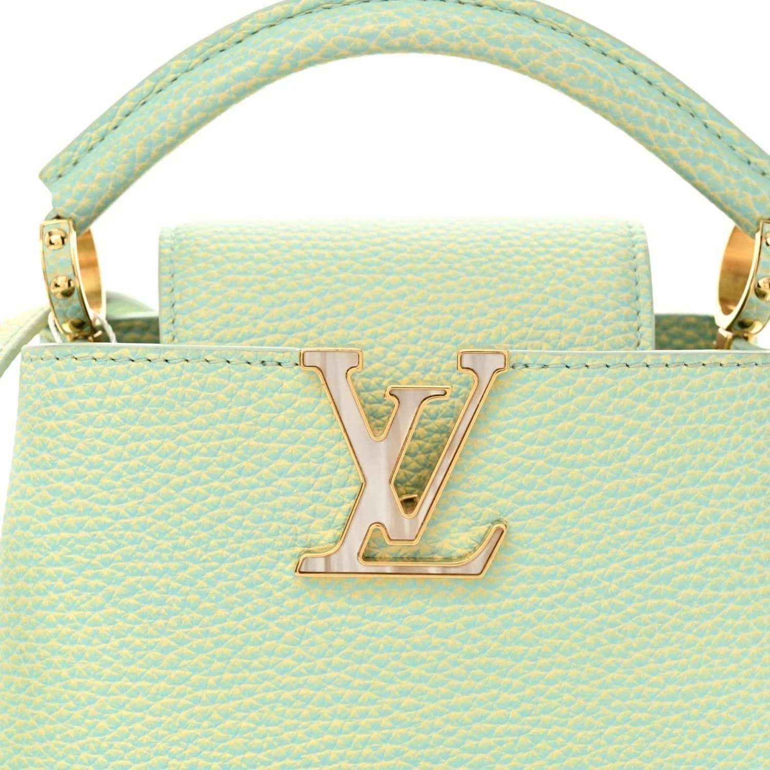 Mini Capucines handbag in light green textured leather with LV emblem and handles