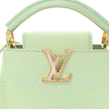Mini Capucines handbag in light green textured leather with LV emblem and handles