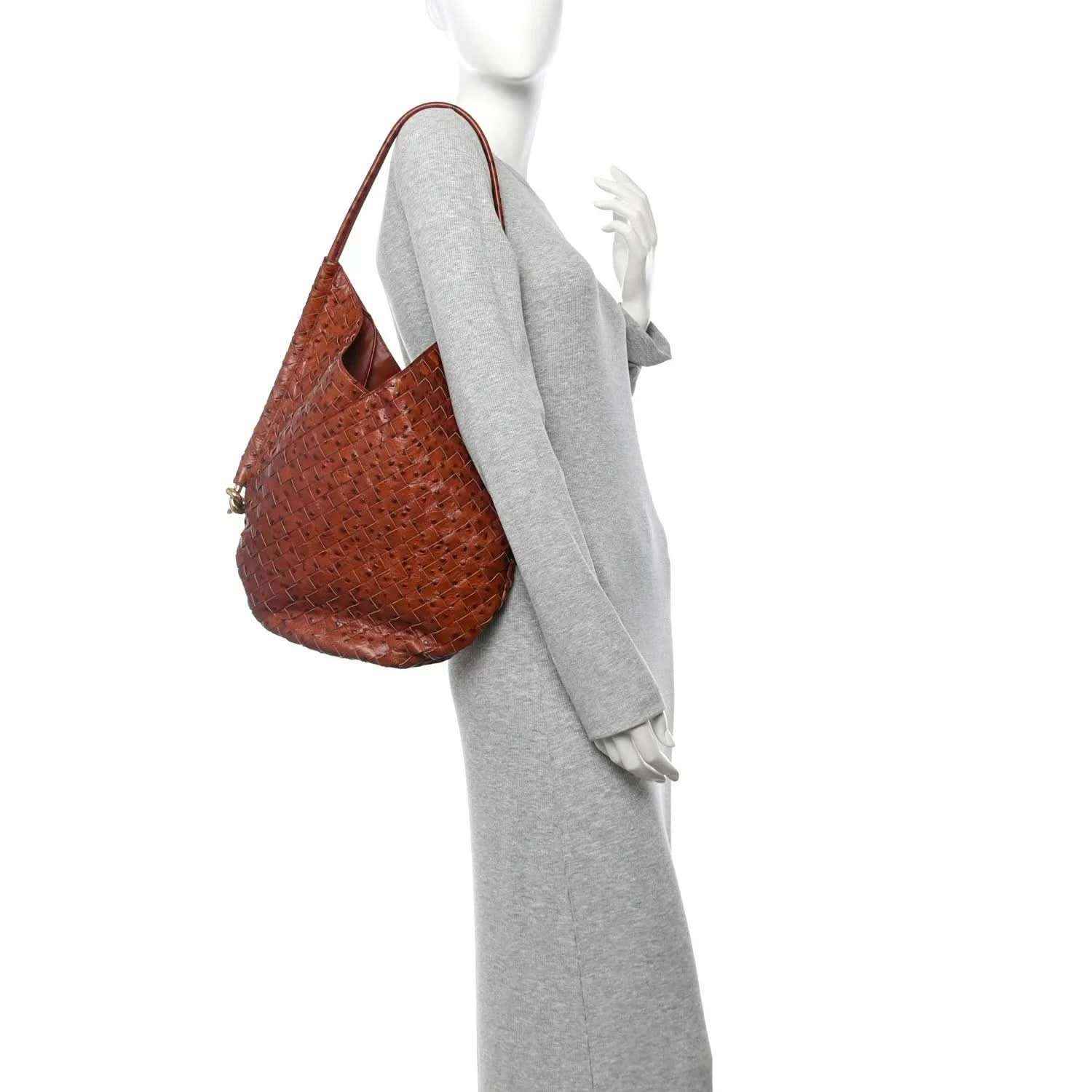Brown hobo bag with one shoulder strap and woven intrecciato leather texture.