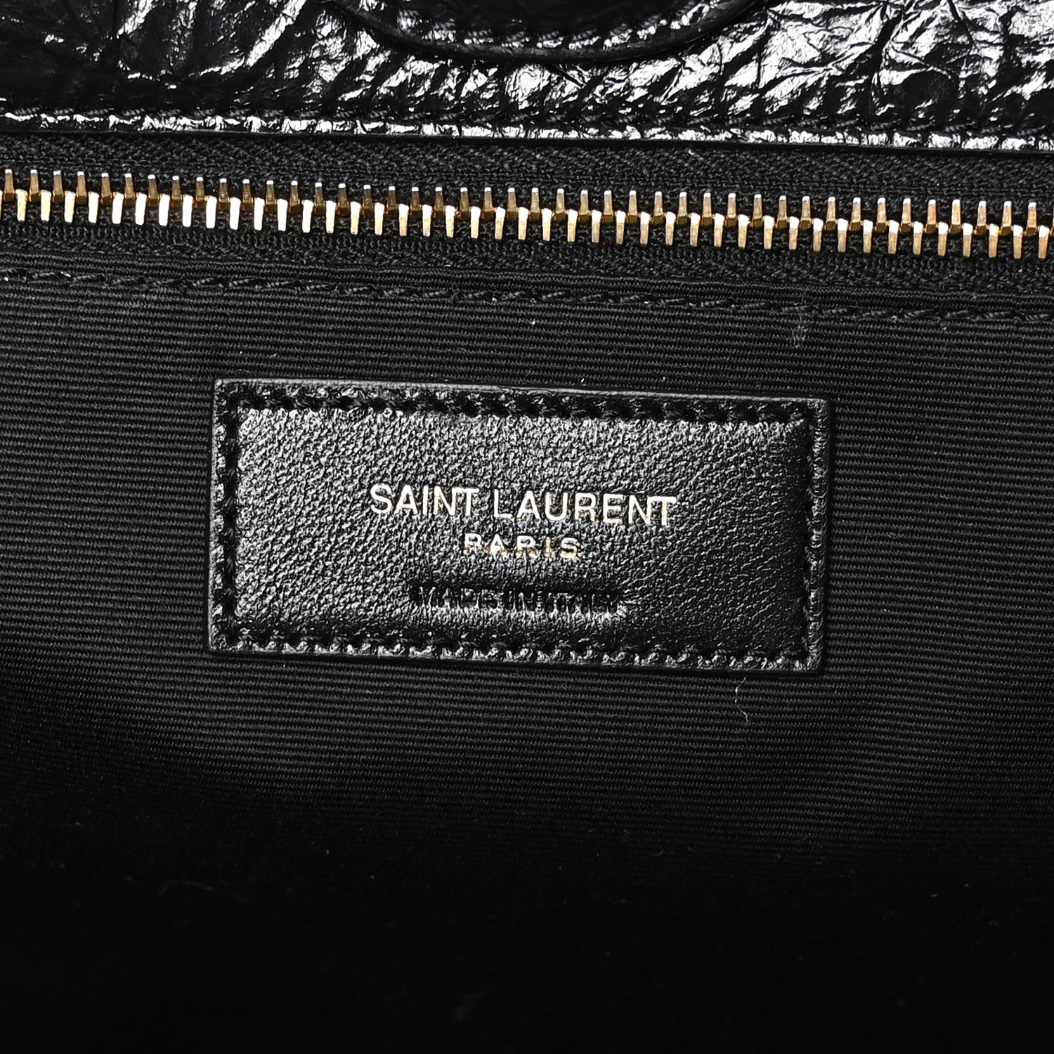 Black leather interior label with SAINT LAURENT PARIS text and gold zipper
