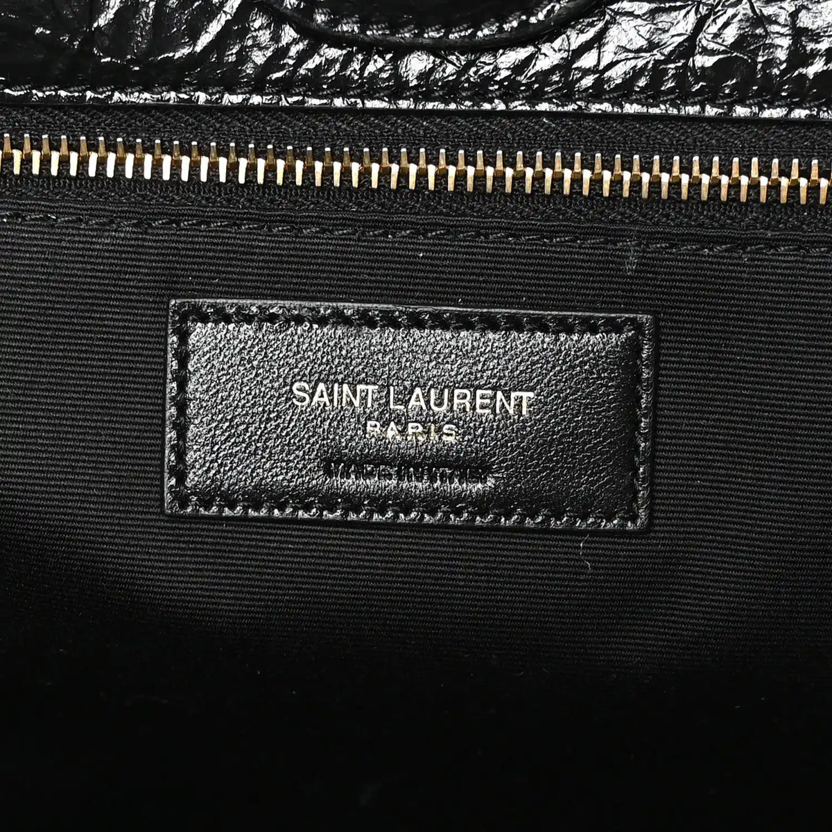 Black leather interior label with SAINT LAURENT PARIS text and gold zipper