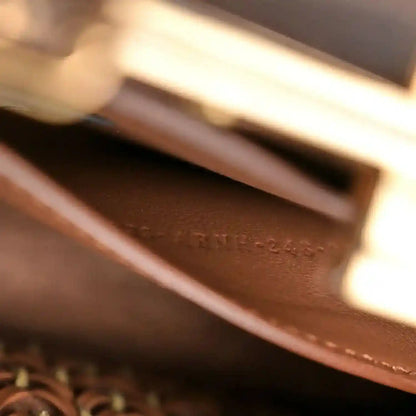 Brown leather interior pocket panel with stitching inside the satchel