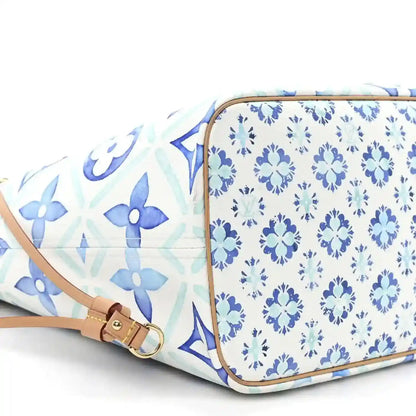 Louis Vuitton Neverfull blue patterned side with tan belt strap and zip corner
