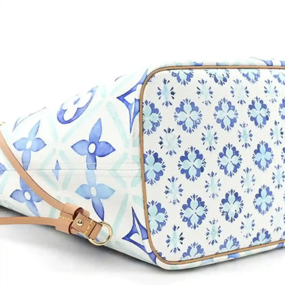 Louis Vuitton Neverfull blue patterned side with tan belt strap and zip corner