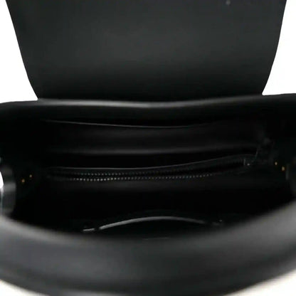 Matte black leather handbag with open top and visible zipper pocket