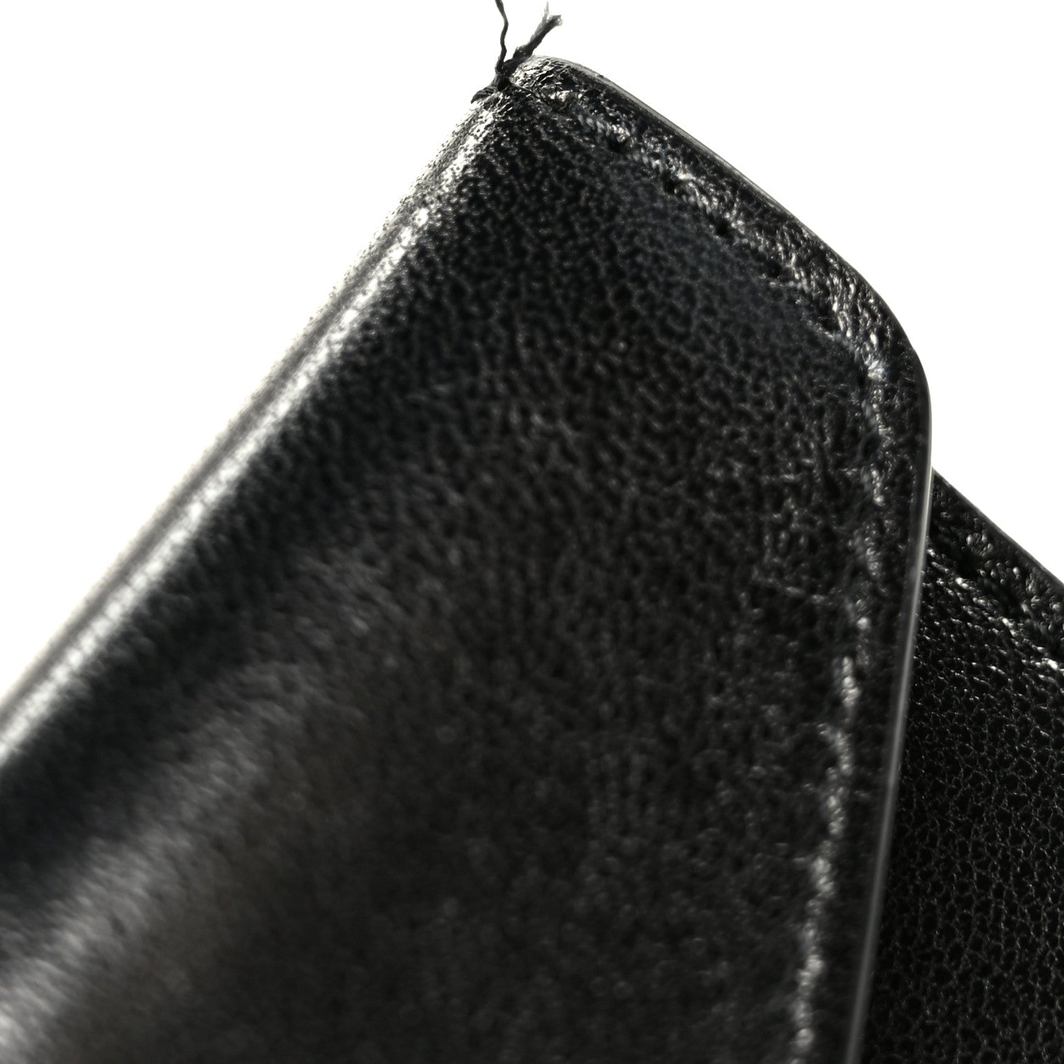 Black lambskin shoulder bag edge close-up with textured grain