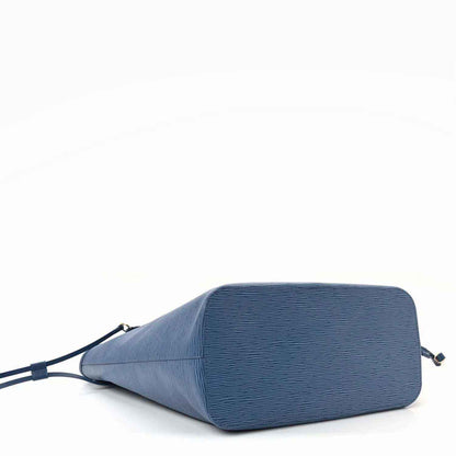 Denim blue leather tote bag, side profile with textured finish and top zipper track
