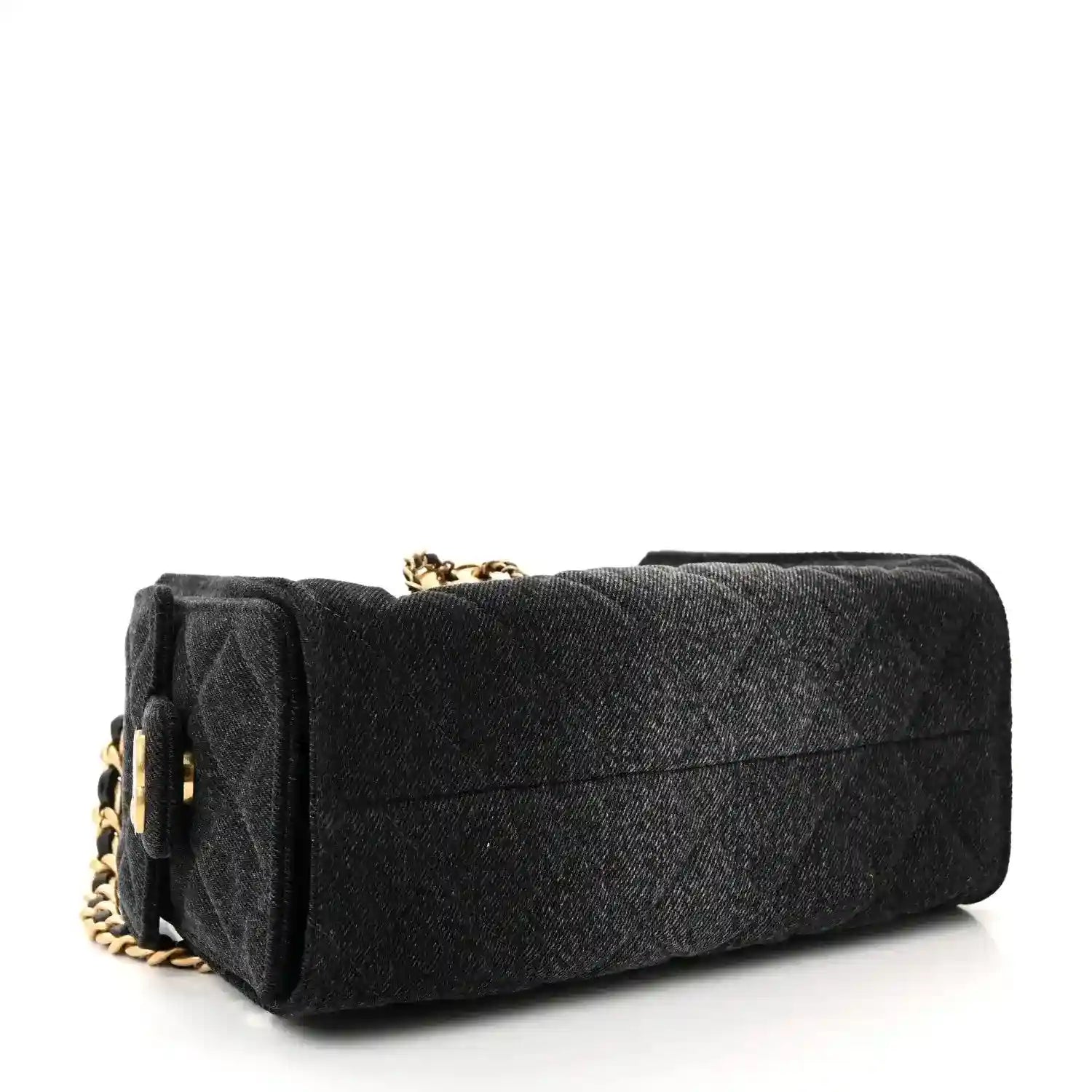Black mini handbag with quilted texture, gold chain strap, structured top flap