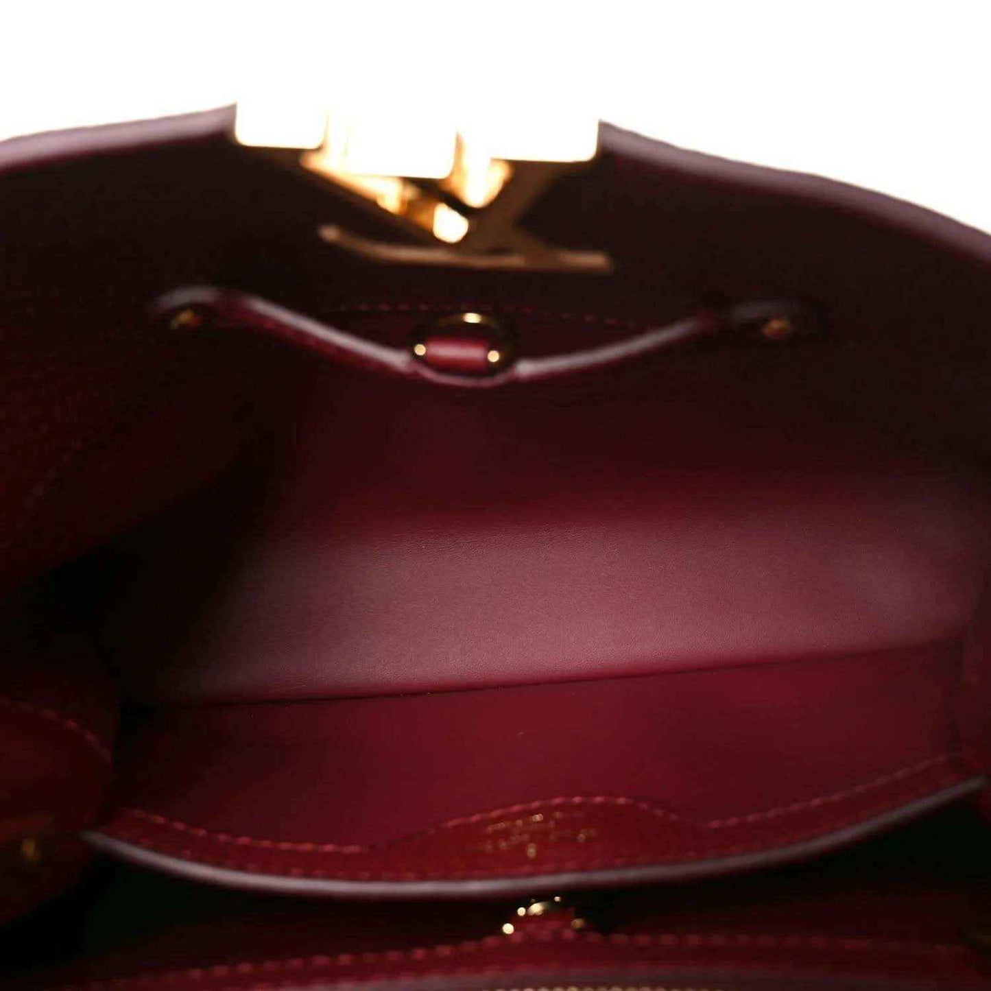 Burgundy leather interior with stitching and small clasp hardware visible.