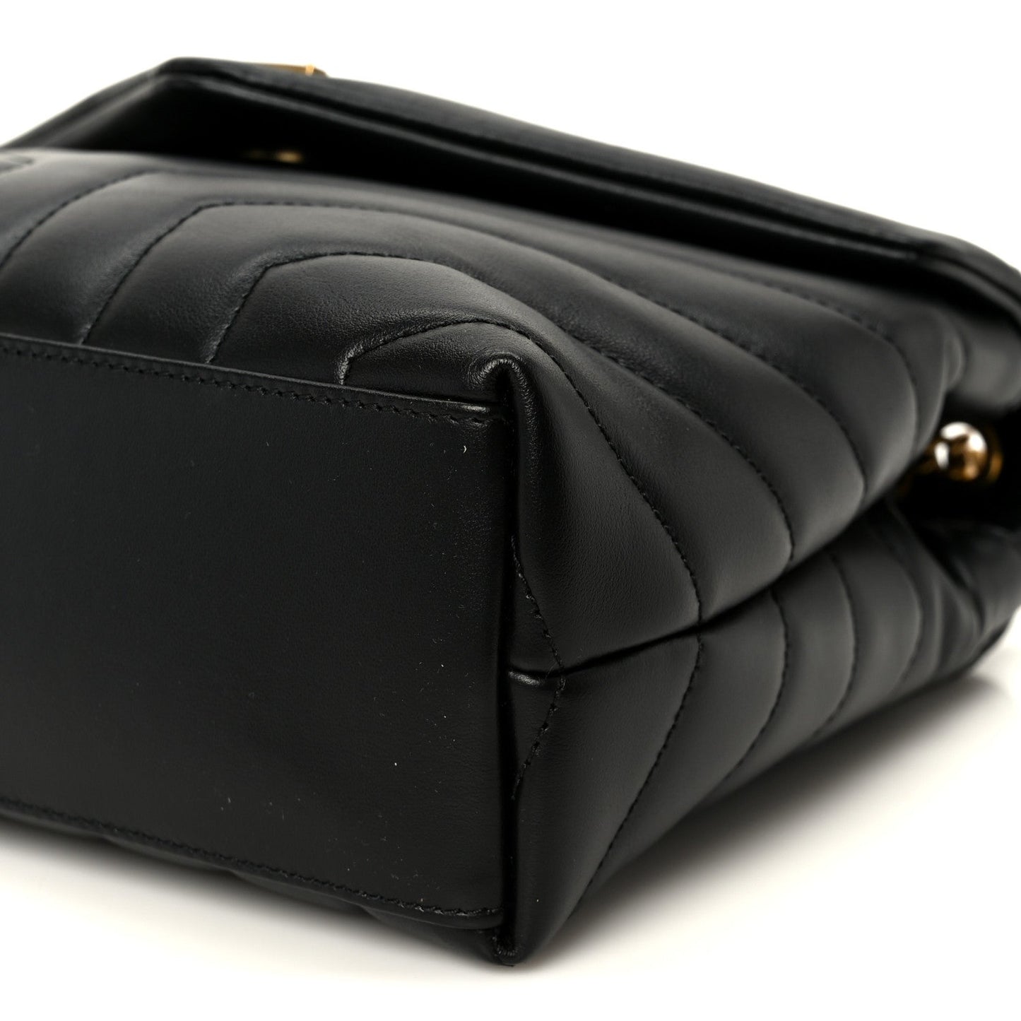 Black quilted leather satchel end with curved seam lines and top edge detail.