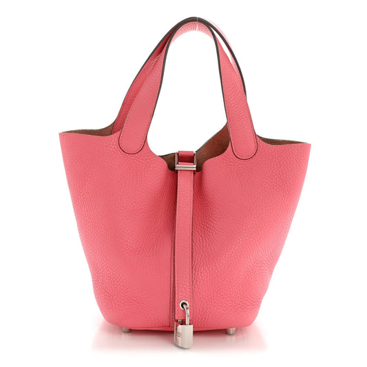 Pink leather tote bag with top lock hardware and matching leather handles