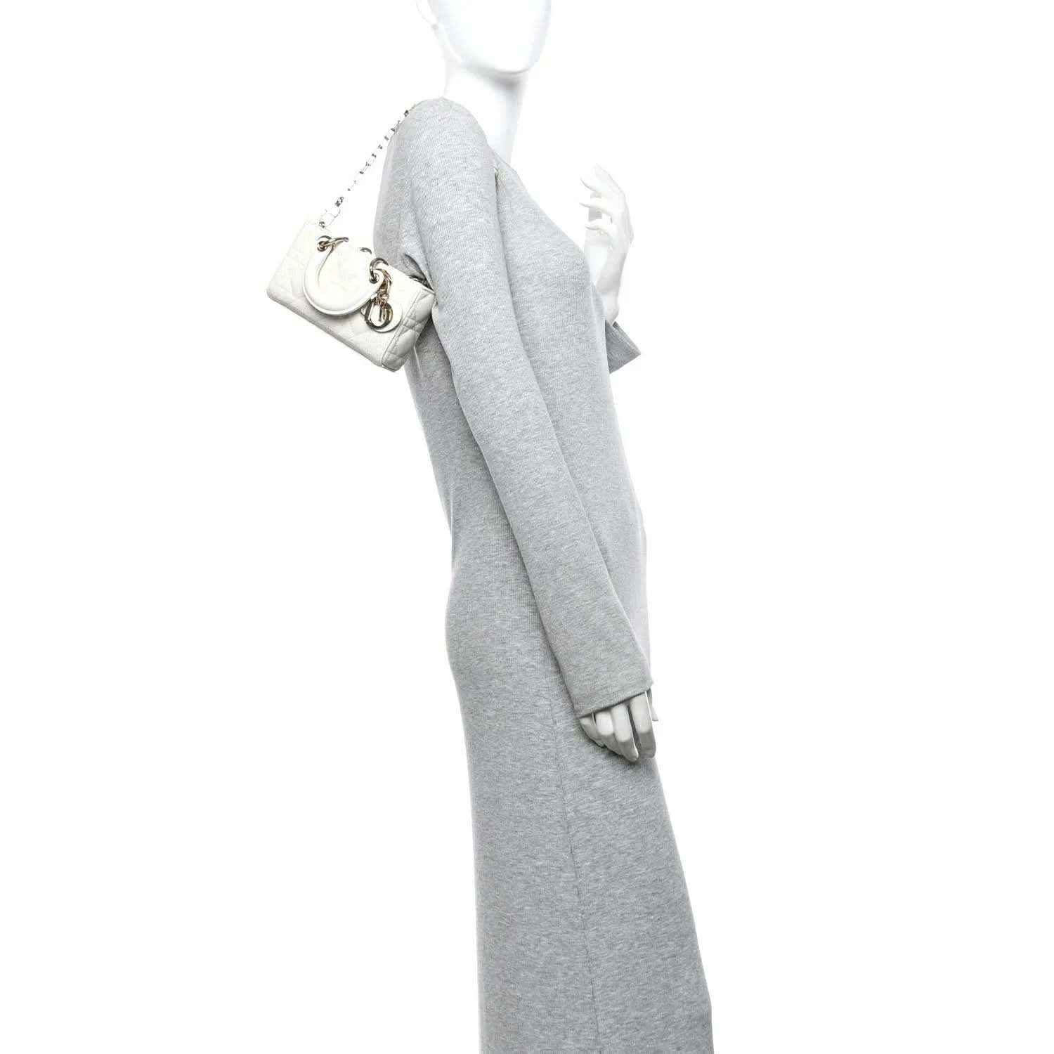 Cream micro lady D-Joy bag with chain strap, held by a person