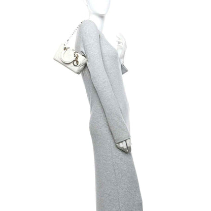 Cream micro lady D-Joy bag with chain strap, held by a person