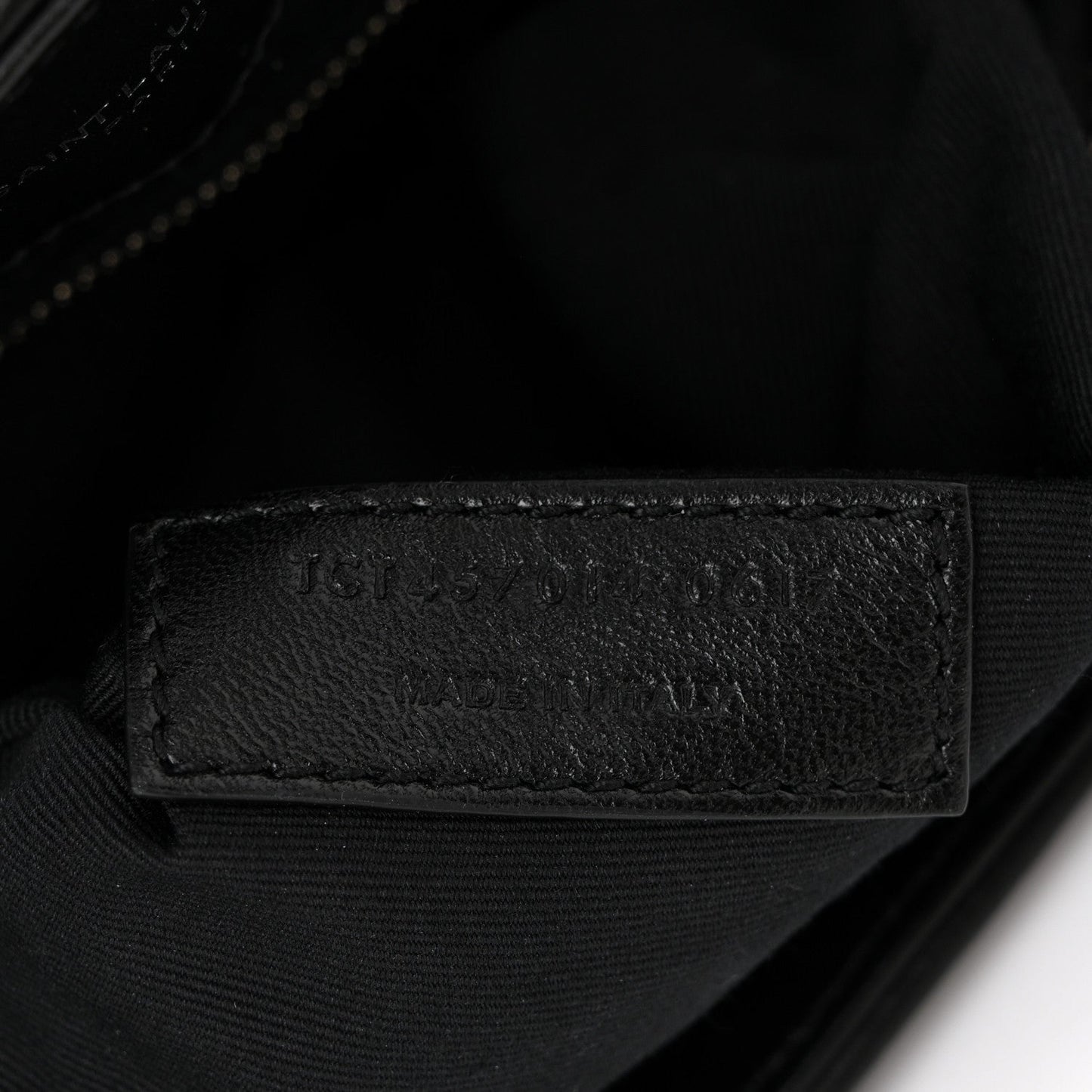 Black leather interior stamp on quilted satchel lining
