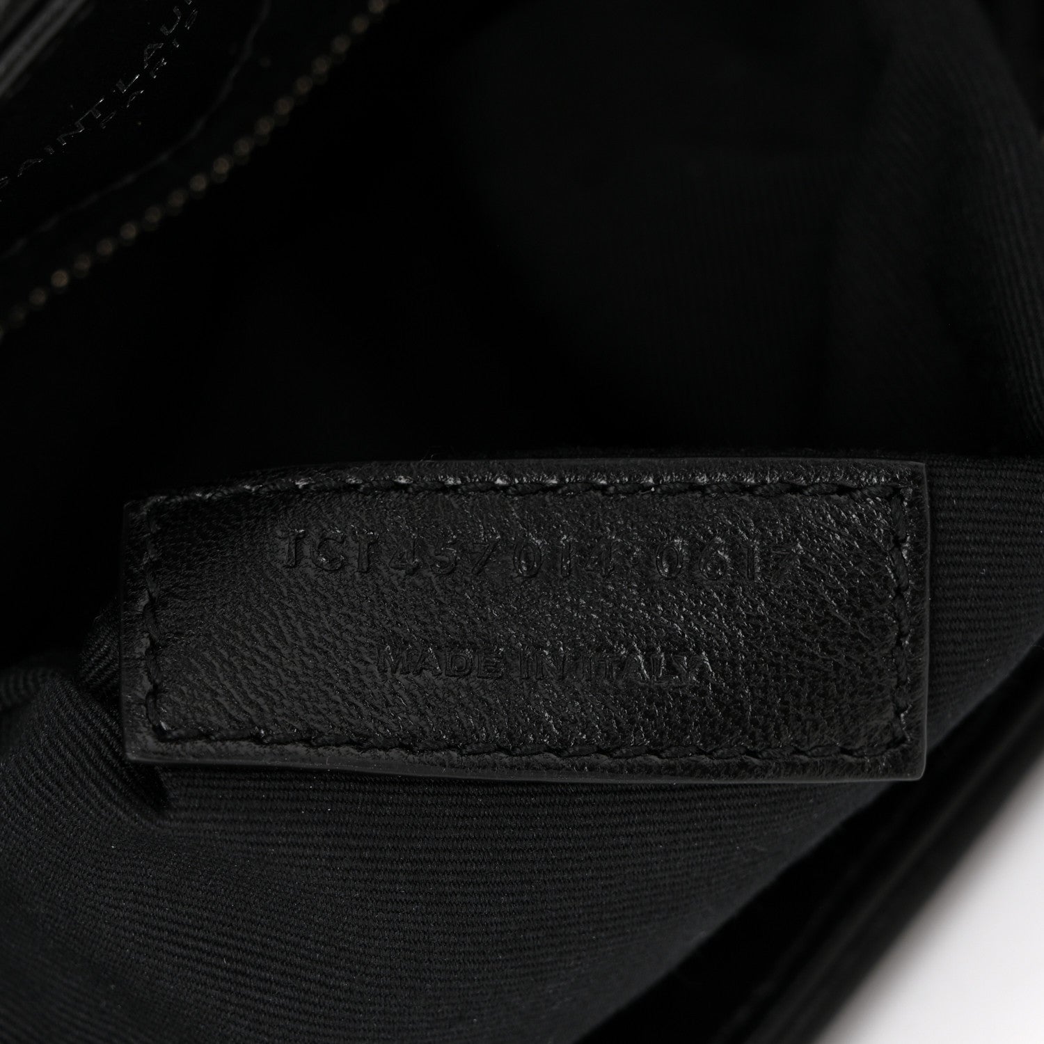 Black leather interior stamp on quilted satchel lining